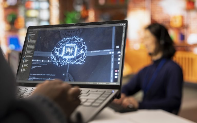 Call center worker uses AI technology on laptop to provide quick replies to common customer queries, close up. Customer service agent generates automated responses to clients using AI tech on notebook